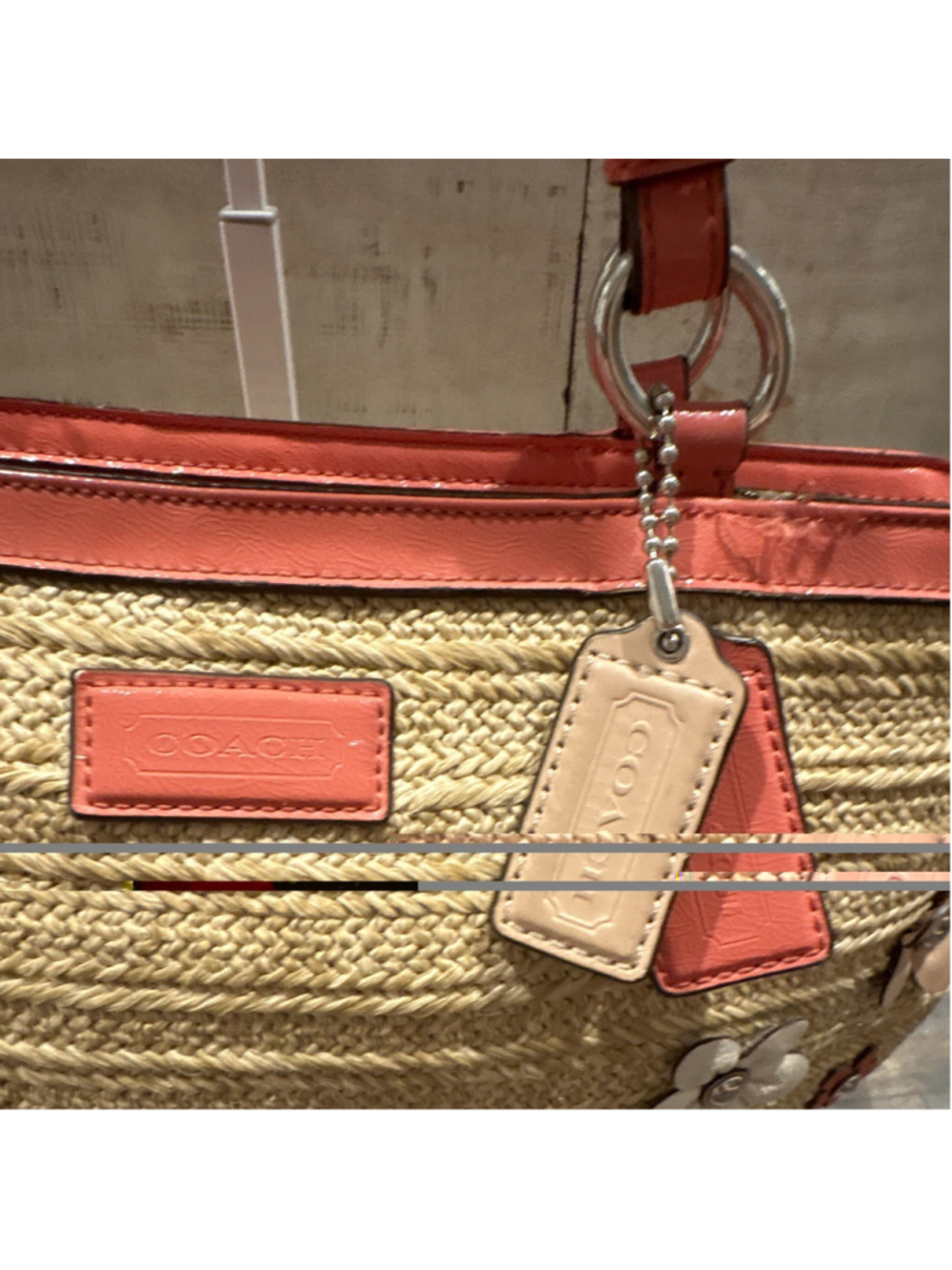 Coach woven straw tote with floral appliqués and coral patent trim